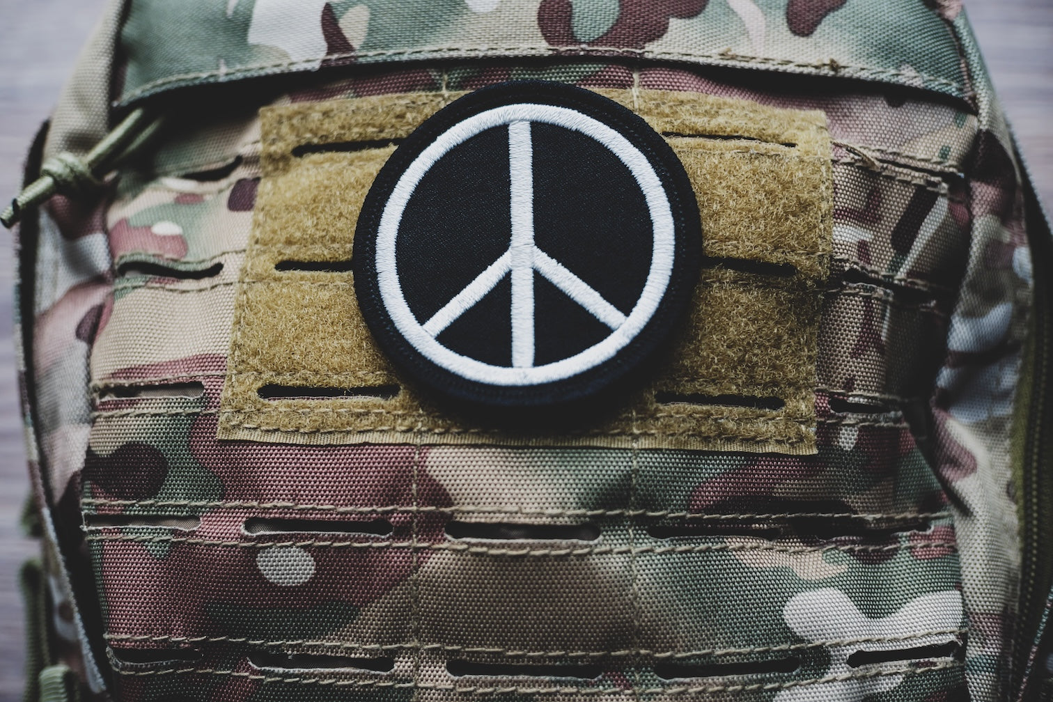 Peace Sign patch on camouflage backpack