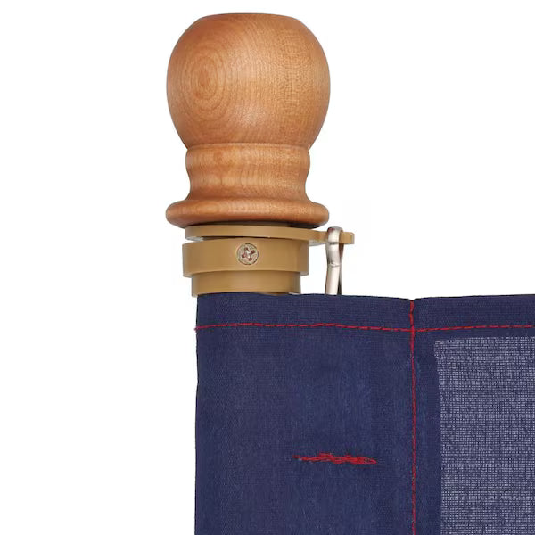 Close-up of a wooden handle with a beige grip on a blue fabric background